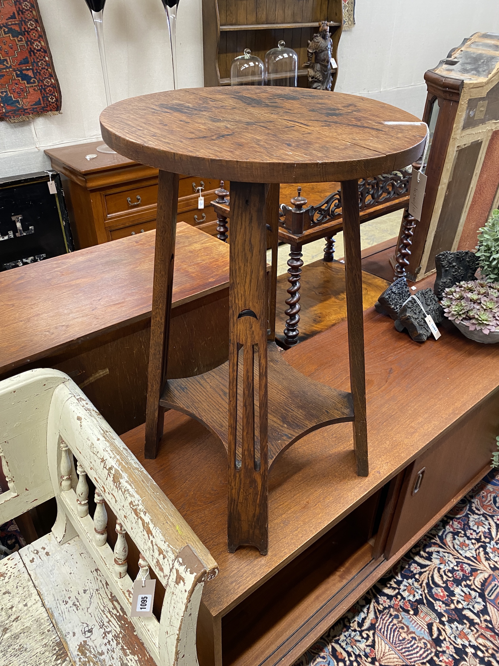 A circular Arts & Crafts oak occasional table, diameter 45cm, height 69cm